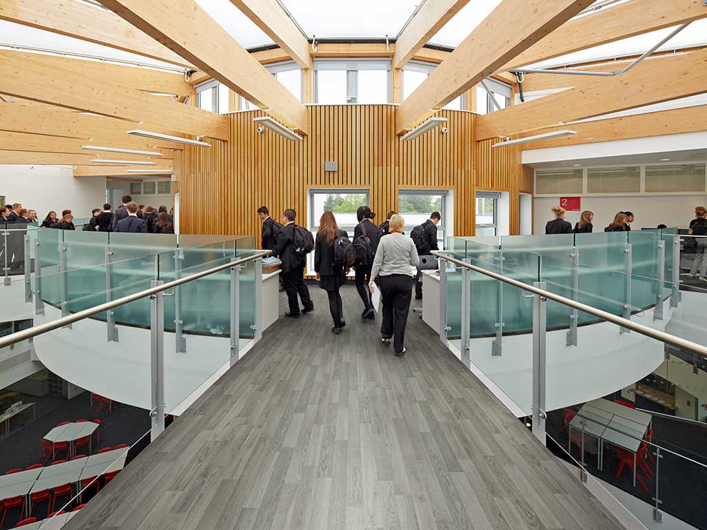 Skinners Academy, Kent, Royal Tunbridge Wells, United Kingdom. Architect: hunters south architects, 2014. Overall view on upper level with passing students.